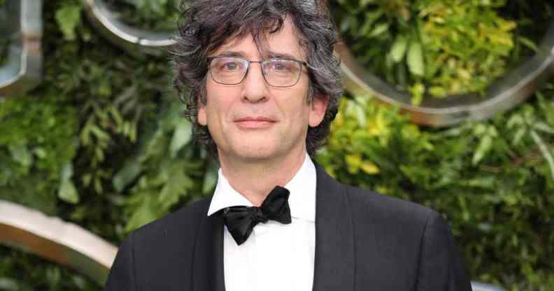 Neil Gaiman attends the global premiere of "Good Omens" in a black and white suit with a black bow tie