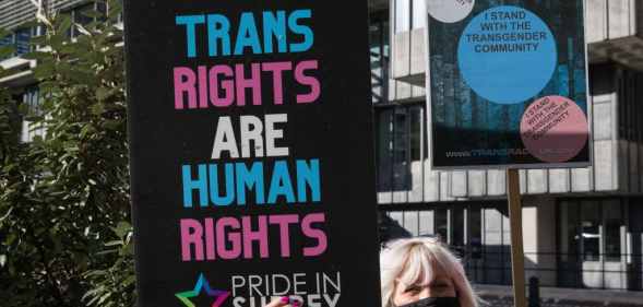 A Pride In Surrey activist protests outside the first annual conference of the LGB Alliance in London