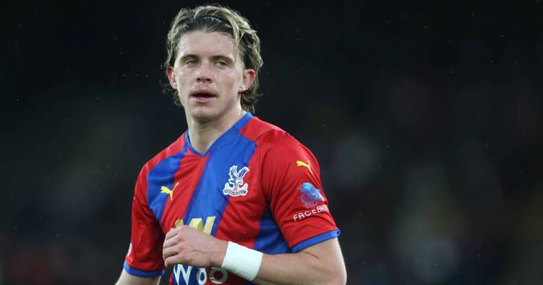 Crystal Palace's Conor Gallagher standing on a football pitch during a match against Aston Villa