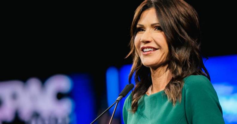 South Dakota governor Kristi Noem wears a gree outfit during her speech at the Conservative Political Action Conference on 11 July 2021