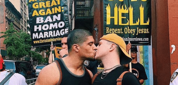 Anthony Bowens kisses boyfriend in front of crowd of homophobic protesters