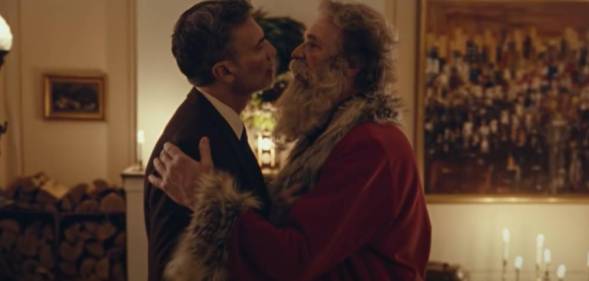 a screenshot of Santa Claus embracing a man in an advert for Postem