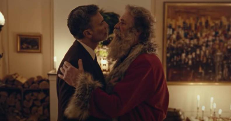 a screenshot of Santa Claus embracing a man in an advert for Postem