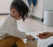 a stock image of a child playing with their parent