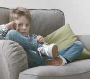 Sad boy sitting on an armchair