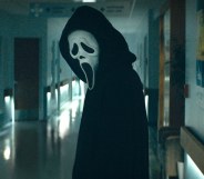 Ghostface in Scream standing in a corridor
