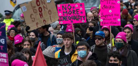 Students marching with placards reading things like 'no more inequality'