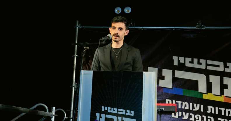 Omri Feinstein speaking at a protest against sexual violence.