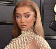 Nikita Dragun is seen in a nude dress with pear-like accents at the Grammy Awards in 2020