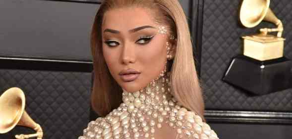 Nikita Dragun is seen in a nude dress with pear-like accents at the Grammy Awards in 2020