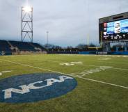 An empty playing field with the NCAA logo on it