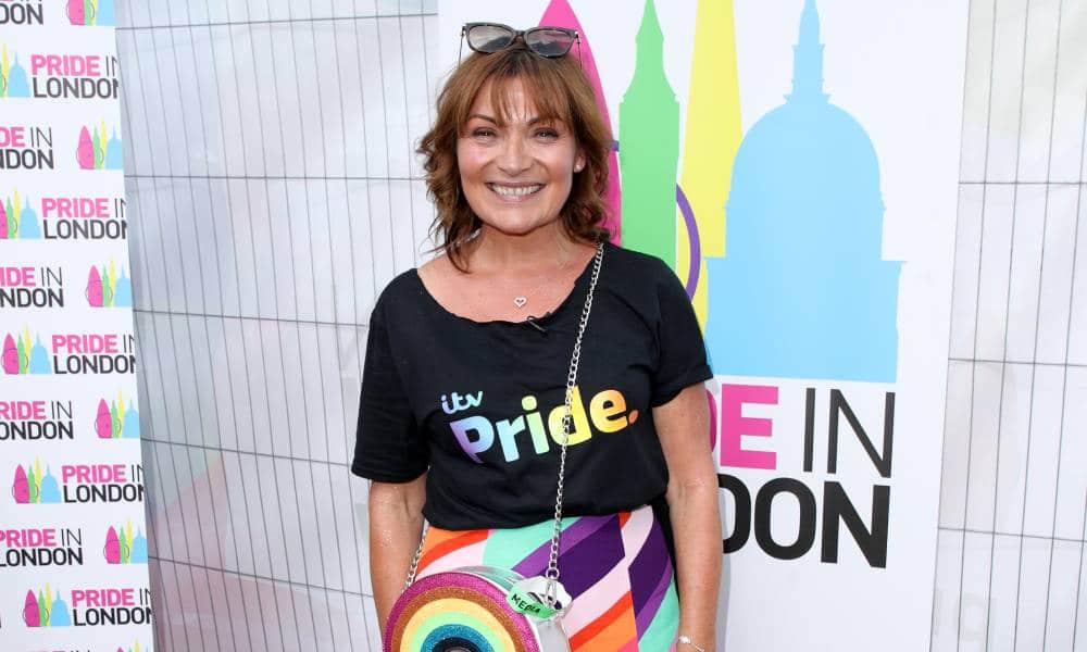 Lorraine Kelly wears a t-shirt that says 'ITV Pride' in rainbow colours and carries a rainbow-shaped bag