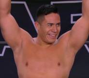 Jake Atlas holds up his arms in triumph after winning his debut match with All Elite Wrestling