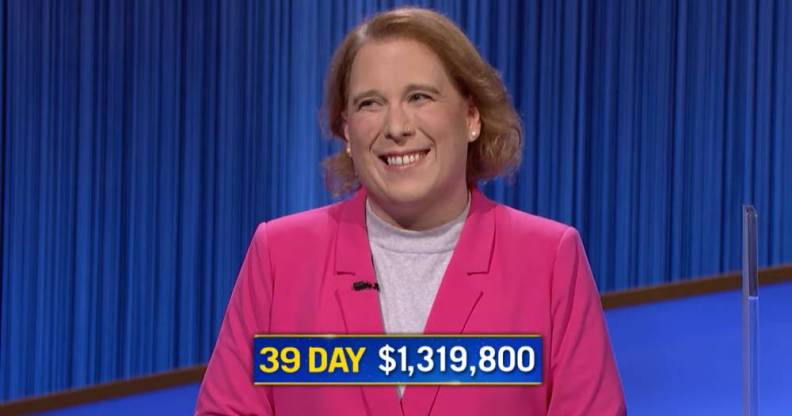 Jeopardy! champion Amy Schneider wears a pink top and darker pink jacket as she smiles after she wins her 39th consecutive game