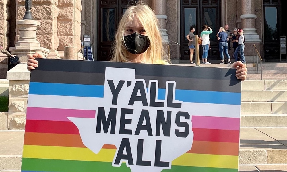 Kai Shappley holding a sign