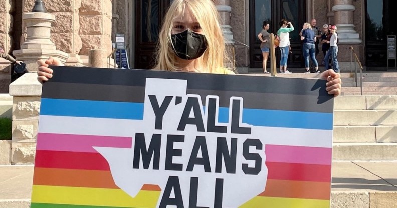 Kai Shappley holding a sign