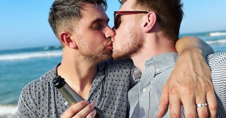 Max Parker and Kris Mochrie share a kiss on the beach