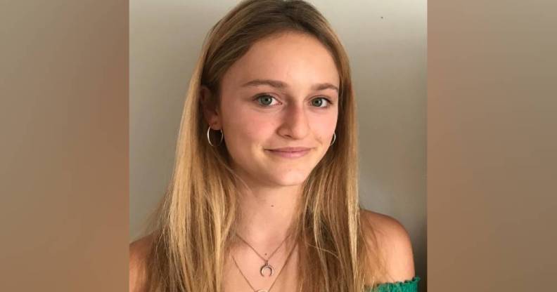 Gemma Tutton smiles at the camera while wearing a green top