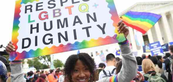 Demonstrators in favour of LGBT+ rights rally outside the US Supreme Court