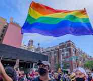 Participants hold LGBT+ rainbow flags during the second annual Queer Liberation March