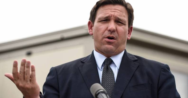 Ron DeSantis wears a suit and tie during a press conference