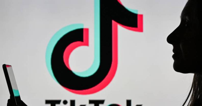 An image of a woman holding a cell phone in front of a TikTok logo displayed on a computer screen