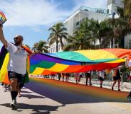 People carry the Rainbow Flag as they participate in the Miami Beach Pride Parade