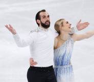 Team USA's Timothy LeDuc and Ashley Cain-Gribble react after skating during the Pair Skating Short Program at the 2022 Beijing Olympics