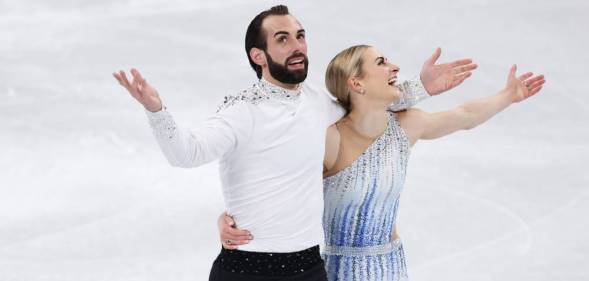 Team USA's Timothy LeDuc and Ashley Cain-Gribble react after skating during the Pair Skating Short Program at the 2022 Beijing Olympics