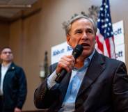 Texas governor Greg Abbott, a white man, speaks into a microphone as he addresses a crowd