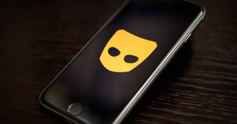 The Grindr app logo is seen on a mobile phone screen