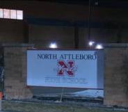 A sign for North Attleboro High School as seen at night