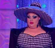 Eureka, a competitor on drag competition RuPaul's Drag Race, wears a black and white patterned outfit and hat