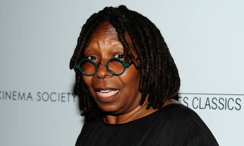 Whoopi Goldberg in round glasses and a black top