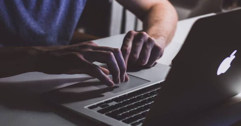 A white person is on a computer watching something on the screen