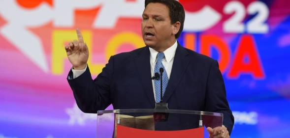 Ron DeSantis, the governor of Florida, wears a dark suit with a blue tie while addressing attendees at the 2022 Conservative Political Action Conference