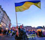 A protester waves a Ukrainian flag during a protest in Krakow, Poland.