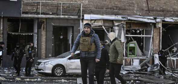 Kyiv's mayor Vitali Klitschko (C) walks in front of a destroyed apartment building, in Kyiv on March 14, 2022.