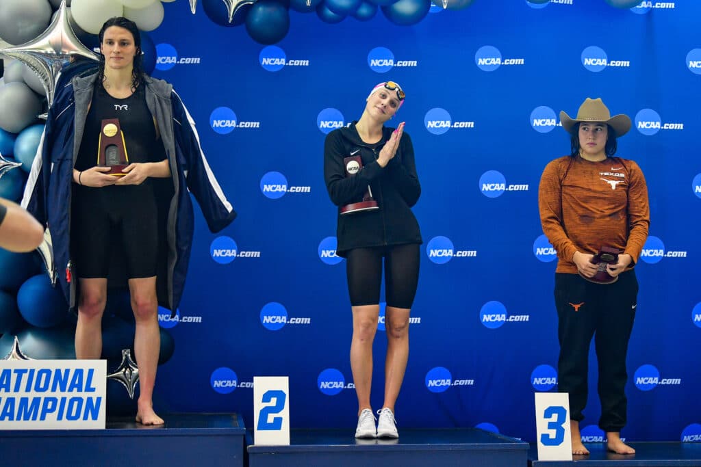 Lia Thomas accepts the winning trophy for the 500 Freestyle finals