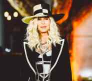 Cher, pop music legend, attends the Academy Museum of Motion Pictures Opening gala wearing a black and white top hat with a black and white sparkly top