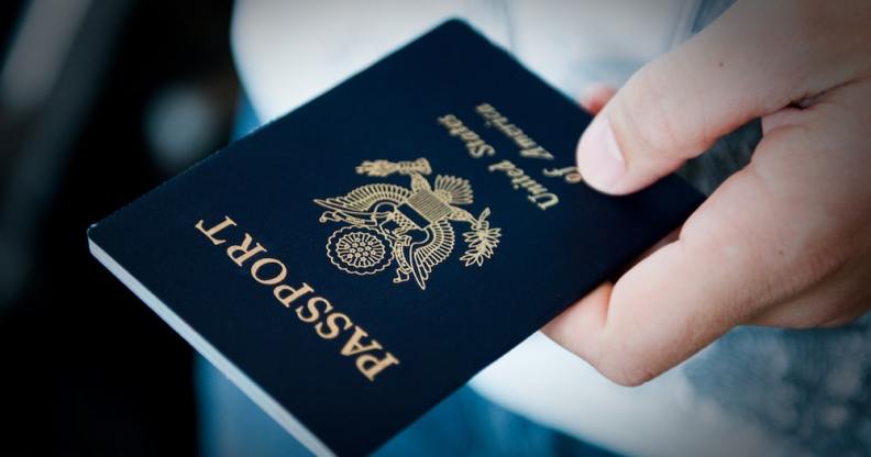 A hand holds a US passport