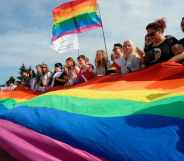 People wave gay rights' movement rainbow flags during the gay pride rally in Saint Petersburg, on Agust 12, 2017.