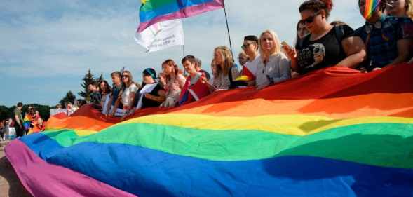 People wave gay rights' movement rainbow flags during the gay pride rally in Saint Petersburg, on Agust 12, 2017.