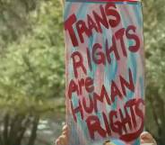 A person holds a sign that reads "Trans rights are human rights"