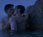 Two men are seen kissing while standing in water in the film Firebird