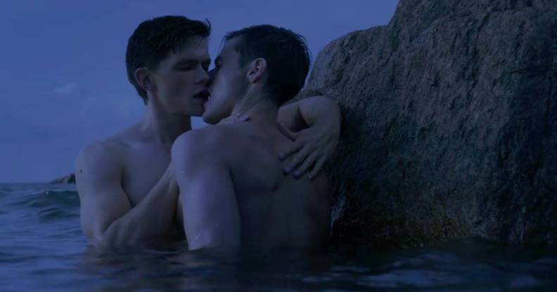 Two men are seen kissing while standing in water in the film Firebird