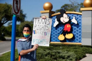 A Disney holds a sign while protesting outside of Walt Disney World on March 22, 2022 in Orlando, Florida.