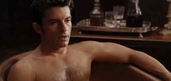 Jonathan Bailey shirtless in a bathtub