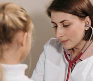 A doctor listens to the heartbeat of a young client