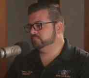 Headshot of Tommy Reyes speaking into a microphone